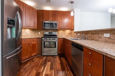 Kitchen with stone counter tops, and stainless app
