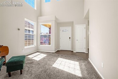 Unfurnished room featuring a towering ceiling, a w