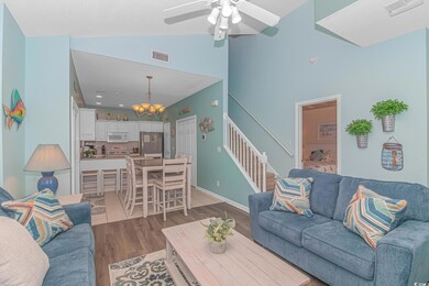Living area featuring stairs, visible vents, vault
