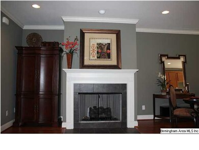GASLOG FIREPLACE IN GREAT ROOM WITH TILE SURROUND.