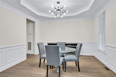 The adjacent formal dining room with tray ceiling makes hosting a delight.