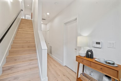 Staircase featuring hardwood / wood-style flooring
