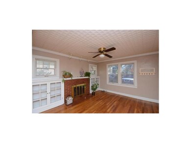 Family room has brick fireplace and great light wi