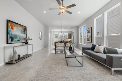 Living area featuring ceiling fan with notable ch