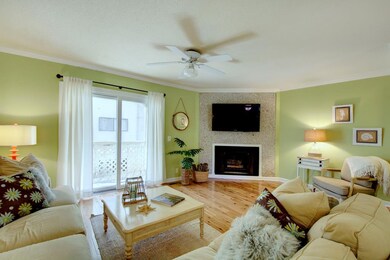 Greatroom with fireplace opens to balcony