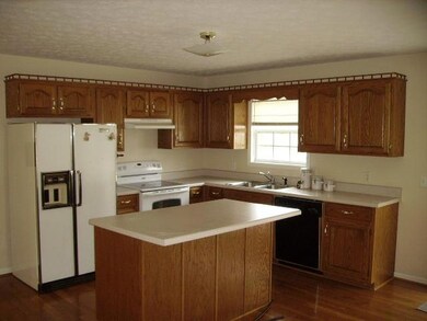 Kitchen with Oak Cabinets and Center Island, Refrigerator, Cook Stove and Dishwasher