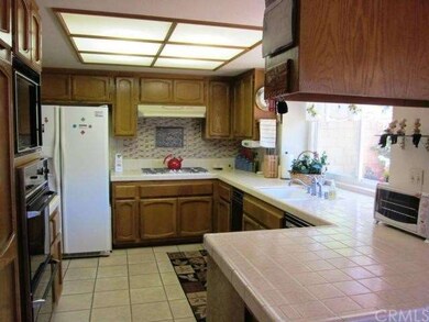 Kitchen with window looking out to backyard.