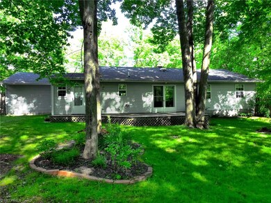 Rear view of house with deck.  Door at left leads 