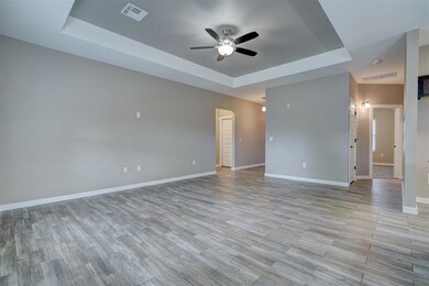 Unfurnished room featuring ceiling fan and a tray 