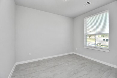Experience the perfect blend of sophistication and warmth in this home office, boasting elegant wood-look tile flooring and flooded with natural light from expansive windows and French doors. Sample photo of completed home with similar floor plan. Actual colors and selections may vary.
