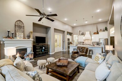 Your incredibly huge living/family area is warm and inviting, with its high ceiling and pallette of sheer earth tones. Recessed wall space is perfect for your special treasures, while maintaining generous floor space! The gas connected fireplace is sure to warm spirits in any weather! Up center is your incredible chef's kitchen, sharing common space with the luxury of this lay out!