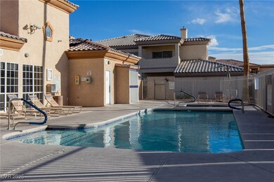 Community pool with fence and a patio