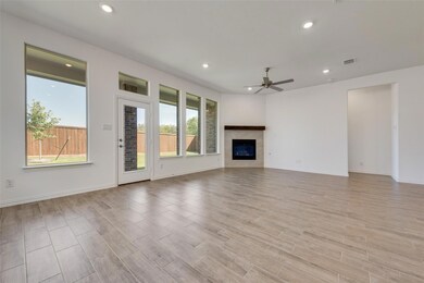 Unfurnished living room featuring ceiling fan, lig