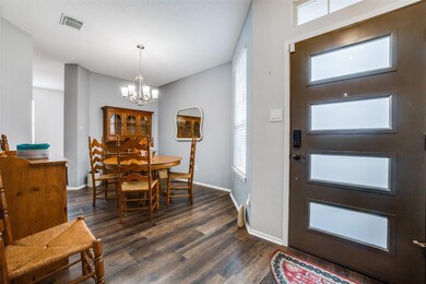Entryway with a notable chandelier, dark hardwood / wood-style flooring, and plenty of natural light