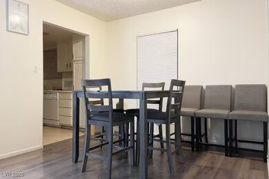 Dining space with a textured ceiling, wood finishe