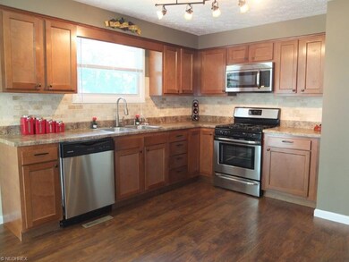 Open kitchen with stainless steel appliances.