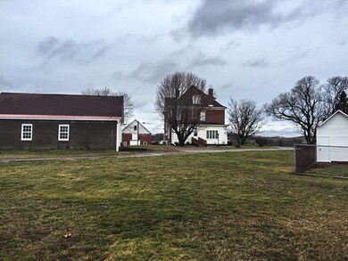 Rear view of the farmhouse, 3 car detached garage,