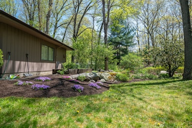 Something is always blooming at 291 Peddlers Road. The side yard provides a level grassy area and garden area.