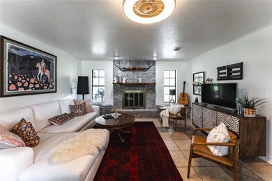 Living area featuring a textured ceiling, a brick