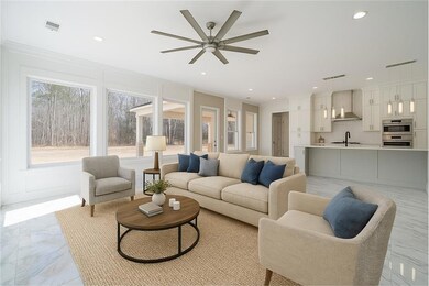Living room with marble finish floor, ceiling fan, ornamental molding, and visible vents. Virtually Staged