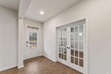 Doorway to outside with recessed lighting, wood fi
