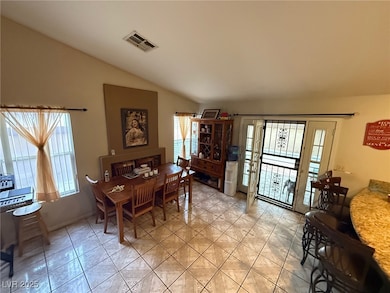Dining space featuring vaulted ceiling, visible ve