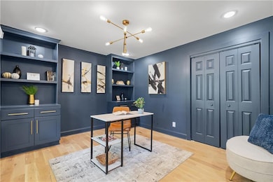 Office space with light wood-style flooring, built