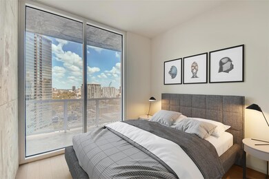 Bedroom with expansive windows, access to exterio