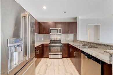 Kitchen with never before Stainless steel appliances with granite countertops, decorative backsplash, breakfast bar and ceramic tile floors