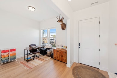 Home office featuring light wood finished floors and baseboards