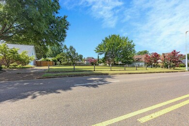 View of asphalt road with sidewalks and curbs
