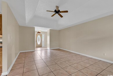 Interior space with ceiling fan, a textured ceilin