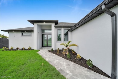 View of exterior entry featuring stucco siding, a