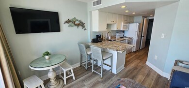Kitchen featuring sink, light stone counters, kitc