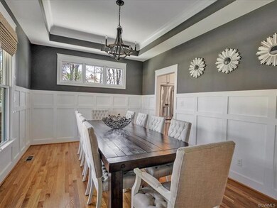 Dramatic formal dining room with tray ceiling, cha