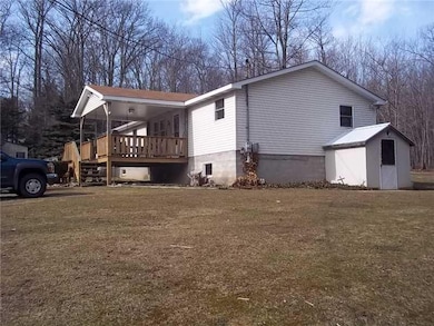 Facade/Exterior Front. Covered front wooden deck.