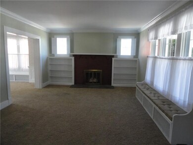 Large living room with gas fireplace, window seats