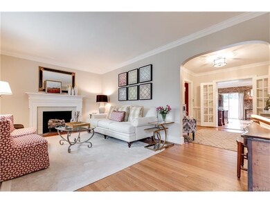 Living room with arched opening to the dining room