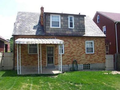 Exterior Back. Covered porch is larger than it loo