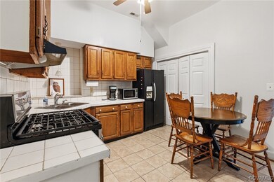 Kitchen featuring a ceiling fan, vaulted ceiling,