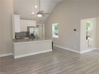 Looking from the front entry door through the living area to the kitchen
