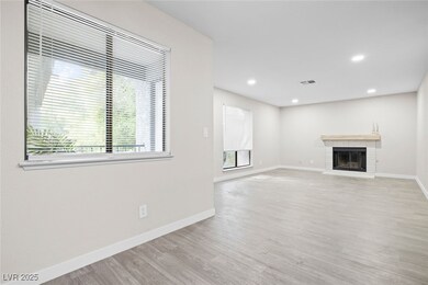 Unfurnished living room featuring wood finished fl