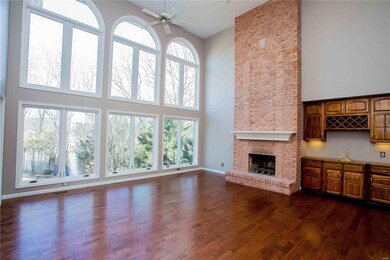 Great room with wall of windows, wood floors, floo