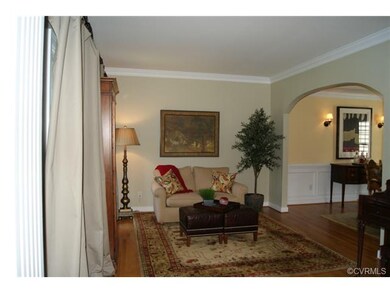 Formal living room has 2 windows,crown molding, ha