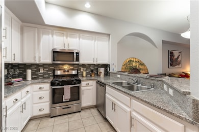 Kitchen featuring stainless steel appliances, grey