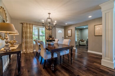 Rich hardwood flooring throughout the living area. Bedrooms are carpeted.