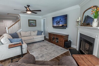 Living room with ceiling fan, dark hardwood / wood