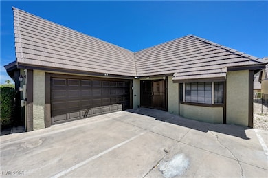 View of front of home featuring stucco siding, dri