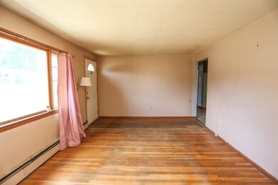 From the far side of the living room, you see the 