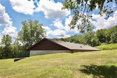 View of side of home featuring a yard